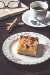 Sweet homemade apple cake and coffee. Breakfast and reading on rustic wooden table.