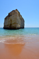 Big cliff surrounded by crystal water