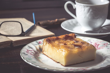 Sweet homemade apple cake and coffee. Breakfast and reading on rustic wooden table.