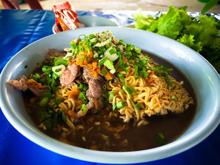 Instant noodles in a bowl, Asian meal on a table