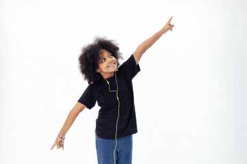 African American afro kid listening the music  with earphones - in white isolated background