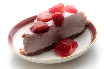 slice of strawberry cheesecake on white background, selective focus