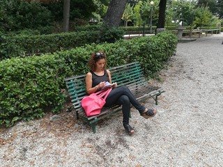 girl reads book at the park