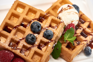 Dessert dish. Belgian waffles with ice cream, blueberries and raspberries.