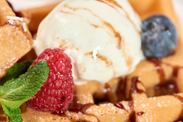 Dessert dish. Belgian waffles with ice cream, blueberries and raspberries.