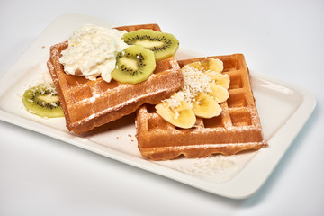 Belgian waffles with banana and kiwi./Dessert Belgian waffles with banana and kiwi.