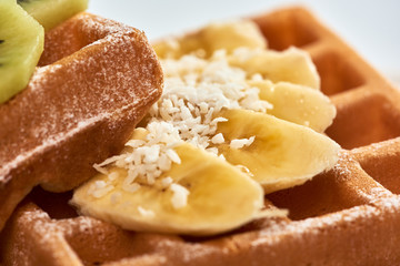 Belgian waffles with banana and kiwi./Dessert Belgian waffles with banana and kiwi.