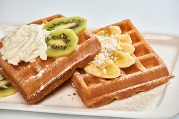 Belgian waffles with banana and kiwi./Dessert Belgian waffles with banana and kiwi.