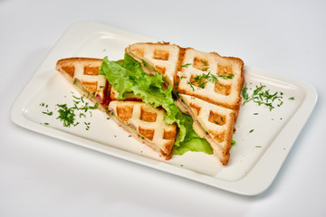 Waffle sandwich with ham and salad./Crispy sandwich with ham and salad. Breakfast.