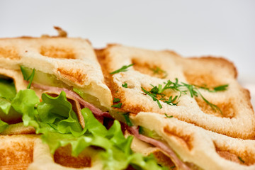 Waffle sandwich with ham and salad./Crispy sandwich with ham and salad. Breakfast.