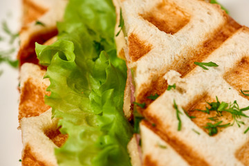 Waffle sandwich with ham and salad./Crispy sandwich with ham and salad. Breakfast.