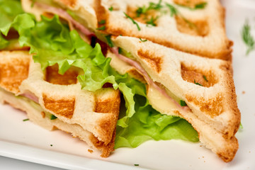 Waffle sandwich with ham and salad./Crispy sandwich with ham and salad. Breakfast.
