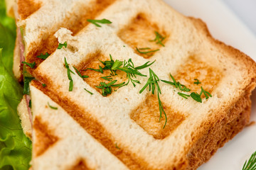 Waffle sandwich with ham and salad./Crispy sandwich with ham and salad. Breakfast.