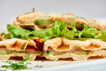 Waffle sandwich with ham and salad./Crispy sandwich with ham and salad. Breakfast.