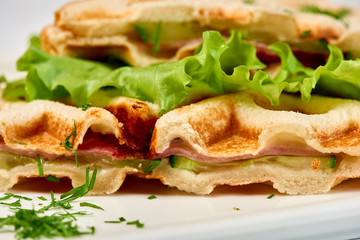 Waffle sandwich with ham and salad./Crispy sandwich with ham and salad. Breakfast.