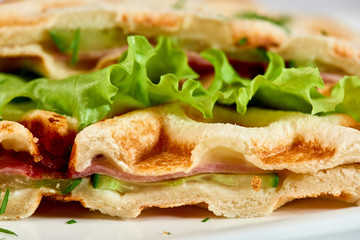 Waffle sandwich with ham and salad./Crispy sandwich with ham and salad. Breakfast.