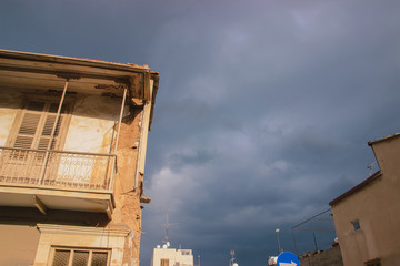 Detail of an abandoned building in cloudy landscape