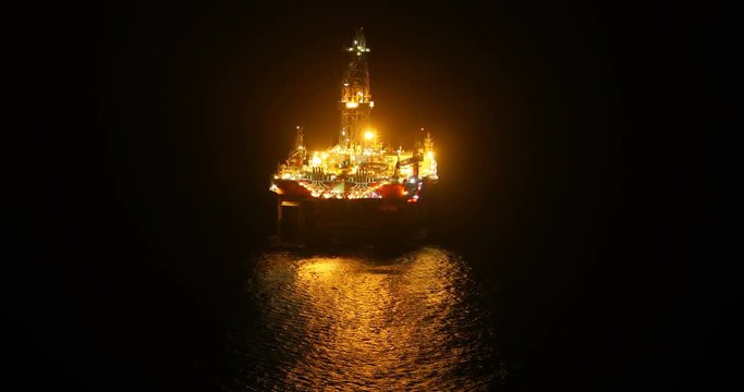 offshore oil and gas well boring platform at night