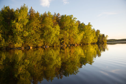 Golden reflection on Finnish lake