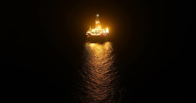 offshore oil and gas well boring platform at night