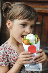 Girl is eating ice cream.