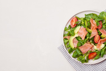Fresh salad made of salmon, tomatoes and avocado
