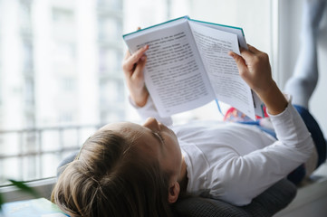 The girl is reading a book.