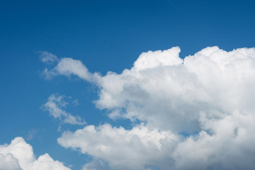 Naklejka na ściany i meble white cumulus clouds on blue sky background