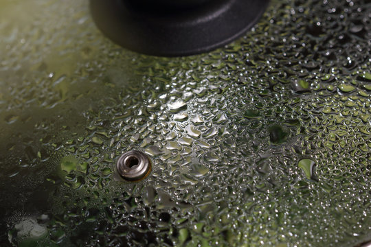 Transparent frying pan cover with droplets of condensed steam