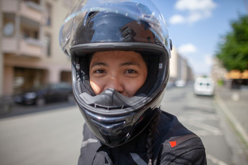 Woman with a black helmet on a motorbike
