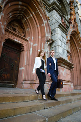 fashion portrait of beautiful young couple posing outdoors