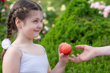 a girl and a boy with a red apple