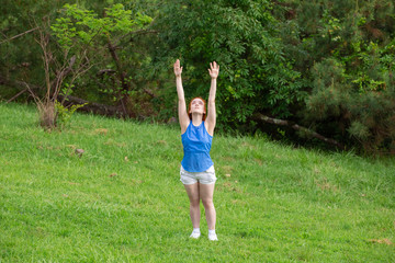 a girl is  doing sports exercises in the park