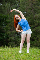 a girl is  doing sports exercises in the park