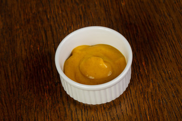 Mustard sauce over wooden
