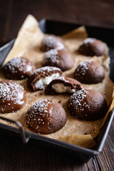 Cocoa biscuits with coconut filling, decorated with chocolate and grated coconut