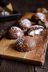 Cocoa biscuits with coconut filling, decorated with chocolate and grated coconut