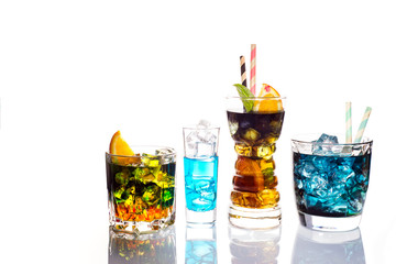 Selection of colorful festive drinks, alcoholic beverages and cocktails in elegant glasses on white