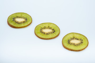 sweet ripe kiwi fruits on white, Kiwi cut into slices lay on a yellow plate, serving fruit