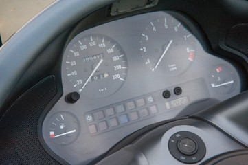three part, red color dashboard of the car and kilometer gauge.