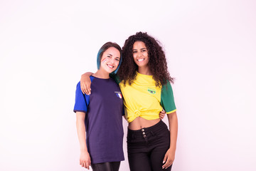 Fototapeta na wymiar Portrait de deux jeunes supportrices de l'équipe du Brésil et de l'équipe de France fraternisant