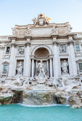 Fototapeta na wymiar Trevi fountain at sunrise, Rome, Italy. Rome baroque architecture and landmark. Rome Trevi fountain is one of the main attractions of Rome and Italy. Panorama. Panoramic view