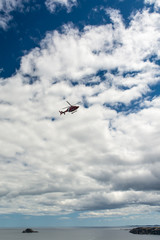 Helicopter Flying Over Coastline