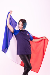 Portrait d'une jeune supportrice de l'équipe de France de football, le drapeau national dans ses mains - obrazy, fototapety, plakaty