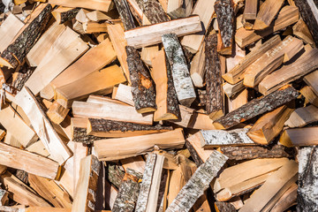 chaotically arranged in a pile of fresh chopped firewood, abstract background