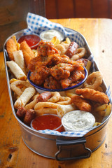 Platter with chicken goujons, crispy chook wings, cocktail sausages, veg spring rolls, onion rings & fries served with dips