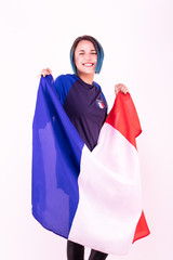 Portrait d'une jeune supportrice de l'équipe de France de football, le drapeau national dans ses mains - obrazy, fototapety, plakaty