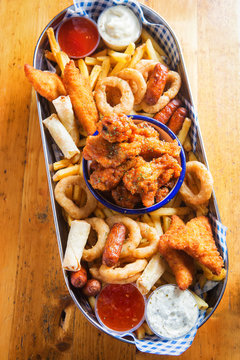 Platter with chicken goujons, crispy chook wings, cocktail sausages, veg spring rolls, onion rings & fries served with dips