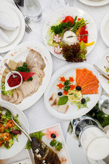 catering table set service with silverware and glass stemware at