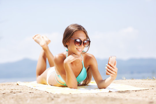 girl taking selfie on a beach